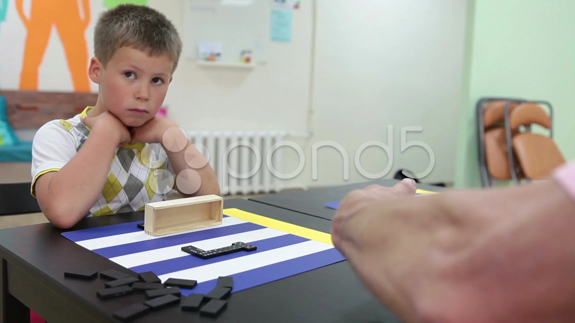 Small boy playing domino with adult man | Stock Video | Pond5