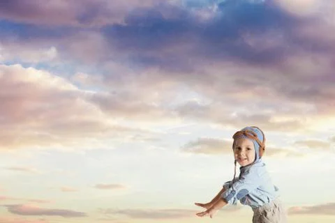 Small boy playing a pilot in knitted helmet Stock Photos