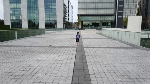 Small Boy Playing With Remote Control Car Outdoors in City Vidéo 93000366