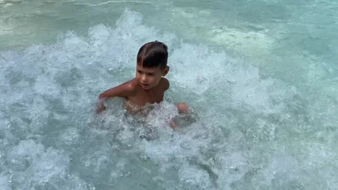 Small boy playing in swimming pool Stock Footage 277608872