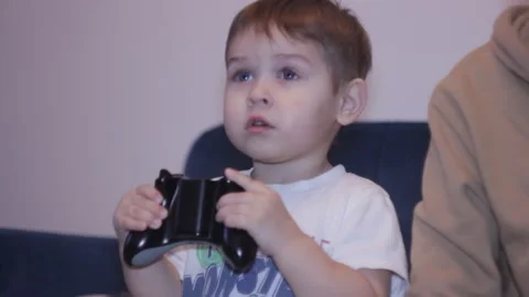 Small boy is playing video game at home Stock Footage 148526903