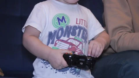 Small boy is playing video game at home Stock Footage 148526915