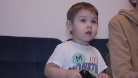 Small boy is playing video game at home Stock Footage 148526937