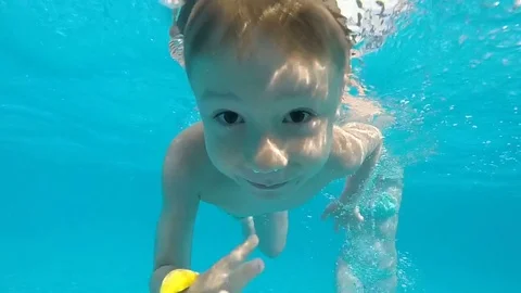 Small boy in pool underwater swimming Video stock 77242432