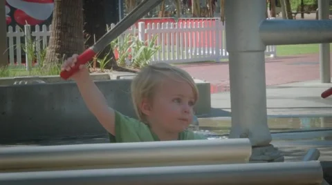 Small boy pumping water at a water park 2 Stock Footage 59131267