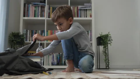 Small boy pupil child prepare his backpack for first day of school Stock-Footage 249813395