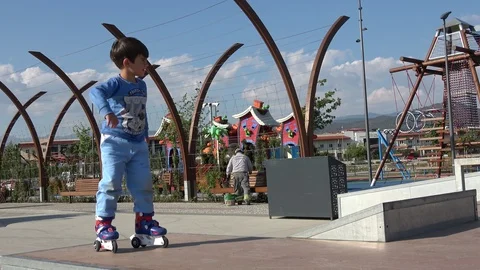 Small boy on roller bladers makes funny movements Stock Footage 107277110