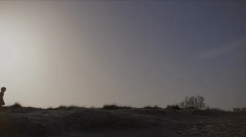 Small boy is running on dunes (SLOMO) Stock Footage 35272820