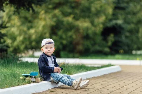 Small boy sit at blur green background Stock Photos