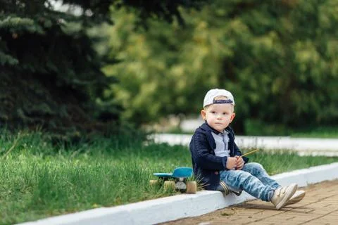 Small boy sit at blur green background Stock Photos