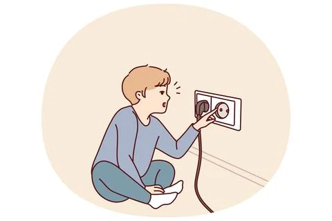 Small boy sticks fingers into socket, playing with electrical equipment and Ilustración de archivo