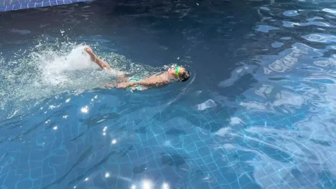 Small boy in swimming goggles learning swimming Stock Footage 277609128