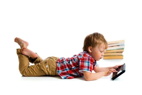 Small boy with tablet computer and books Stock Photos