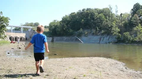 Small boy throwing rocks 動画素材 11858862