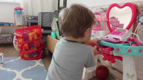Small boy is trying to break up a toy cashdesk at his bedroom 스톡 동영상 123072921