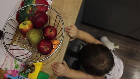 Small boy is trying to reach the apples Stock Footage 123712208