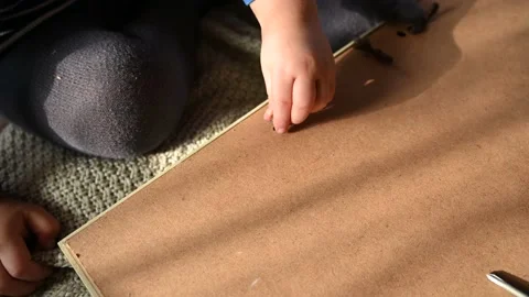 A small boy unscrews the screws with hand. Development of fine motor skills Stock Footage 151596910