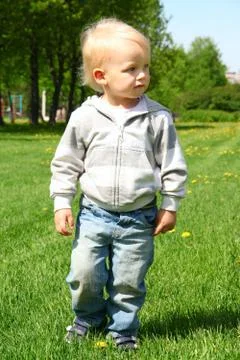 Small boy walking on grass Stock Photos