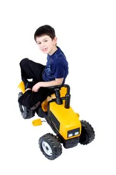 Small boy on the yellow tractor Stock Photos