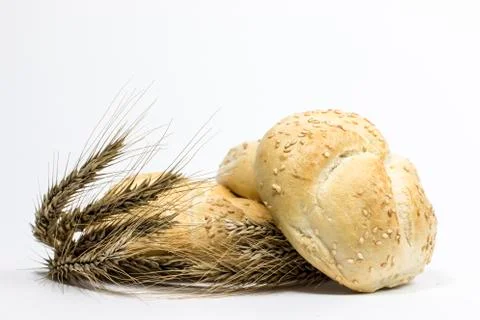 Small bread and wheat ear Stock Photos