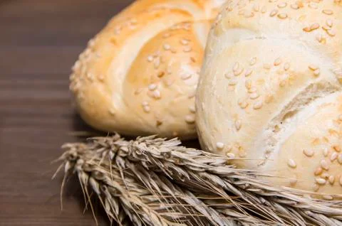 Small bread and wheat ear Stock Photos