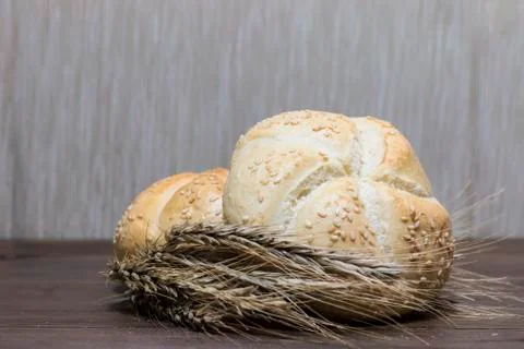 Small bread and wheat ear Stock Photos