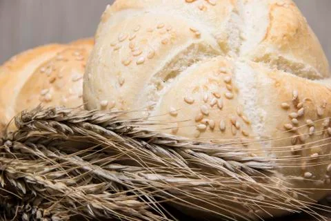 Small bread and wheat ear Stock Photos