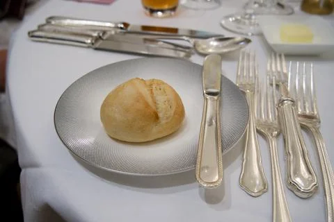 Small bread roll on elegant plate at formal dinner table 스톡 사진