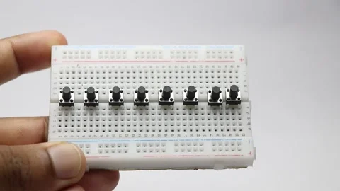 Small breadboard with row of tactile push button switches Stock Footage 346665378