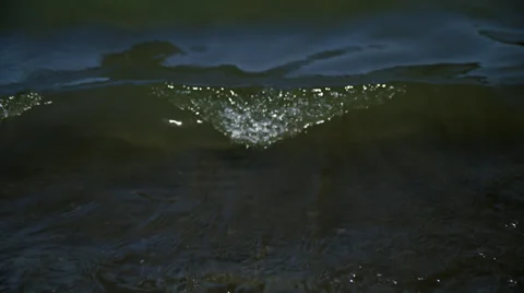 Small breaking waves at shoreline of Lake, tilt up HD Video stock 36985870