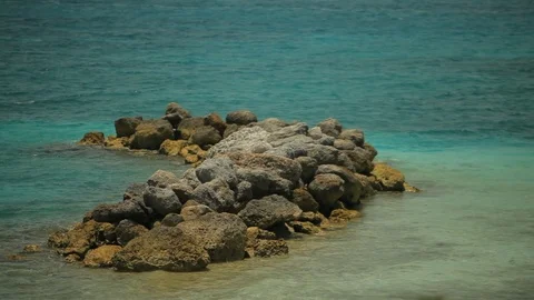 Small breakwater rocks piled up in ocean by the shore Video stock 111590543
