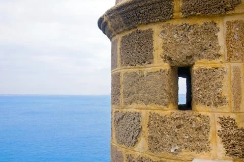 Small brick tower with small windows and sea view, summer, Spain Stock Photos