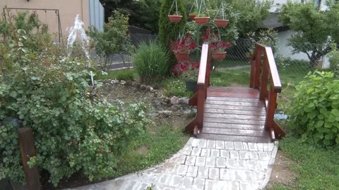 Small bridge in the backyard of a small fountain 스톡 동영상 111253563