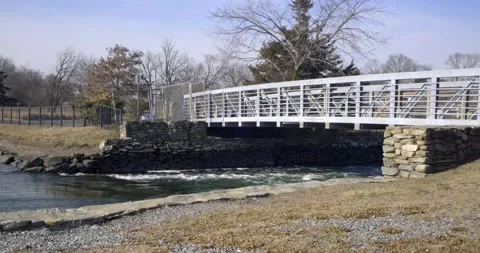 Small bridge crossing over small creek - Cove Island, CT. 4K Stock Footage 172082122
