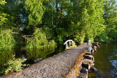Small bridge at lakeside park Stock Photos