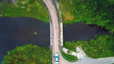 A small bridge over the river on which the car passes. Beautiful view from above Stock Footage 119521374