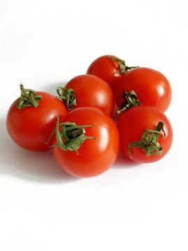 Small bright cherry tomatoes on a white background Stock Photos