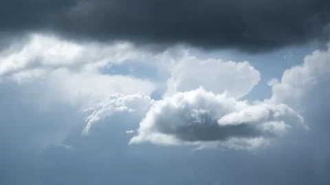 Small bright cloud under dark cloud Stock Photos