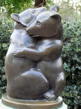 Small bronze statue of two small bears hugging or playing Stock Photos