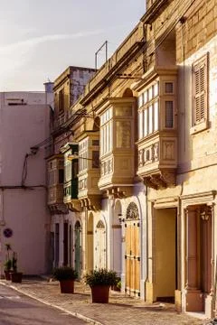 Small brown balconies in sunset rays in the late afternoon Stock Photos