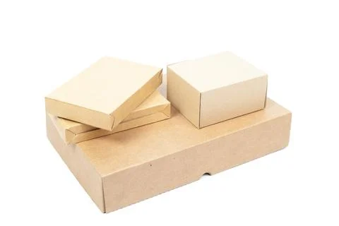 Small brown cardboard boxes stacked on top large box. Stock Photos