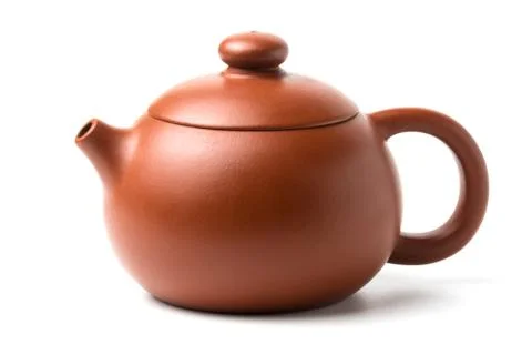 Small brown earthenware teapot isolated on white background Stock Photos