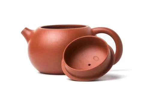 Small brown earthenware teapot isolated on white background Stock Photos