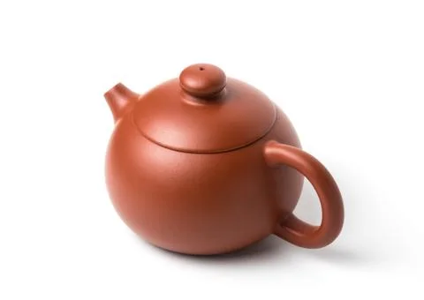 Small brown earthenware teapot isolated on white background Stock Photos