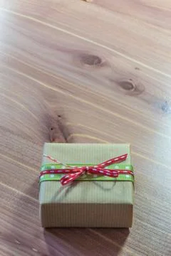 Small brown gift box with both red and green polka dot ribbons Stock Photos