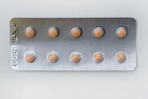 Small brown tablets per pack. Stock Photos