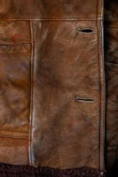 Small brown thick seude jacket closeup texture with selective focus and blur Stock Photos