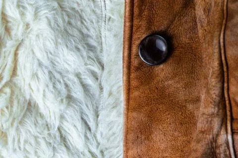 Small brown thick seude jacket with white sheep fur lining closeup texture wi Stock Photos