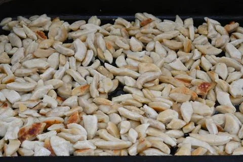 Small browned dough pieces in a baking tray Stock Photos