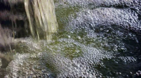 Small Bubbles Moving Energetically from the Base of a Waterfall. Stock Footage 35442811